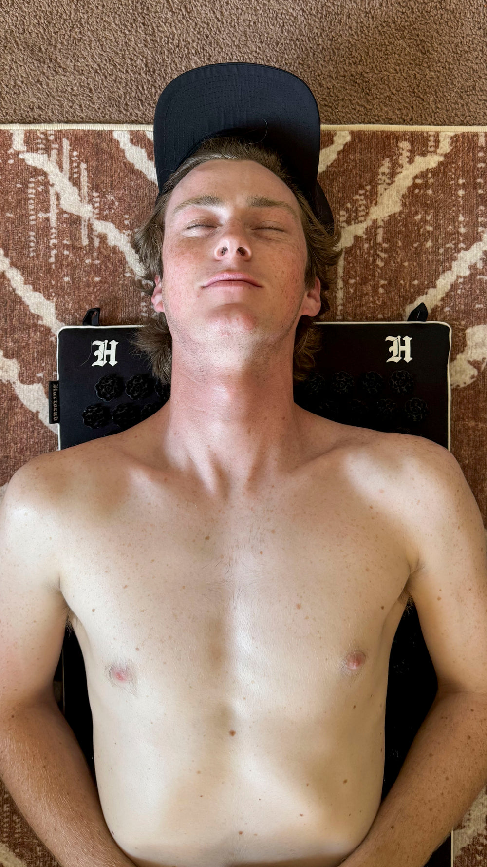 motorcycle rider laying down on his acupressure mat