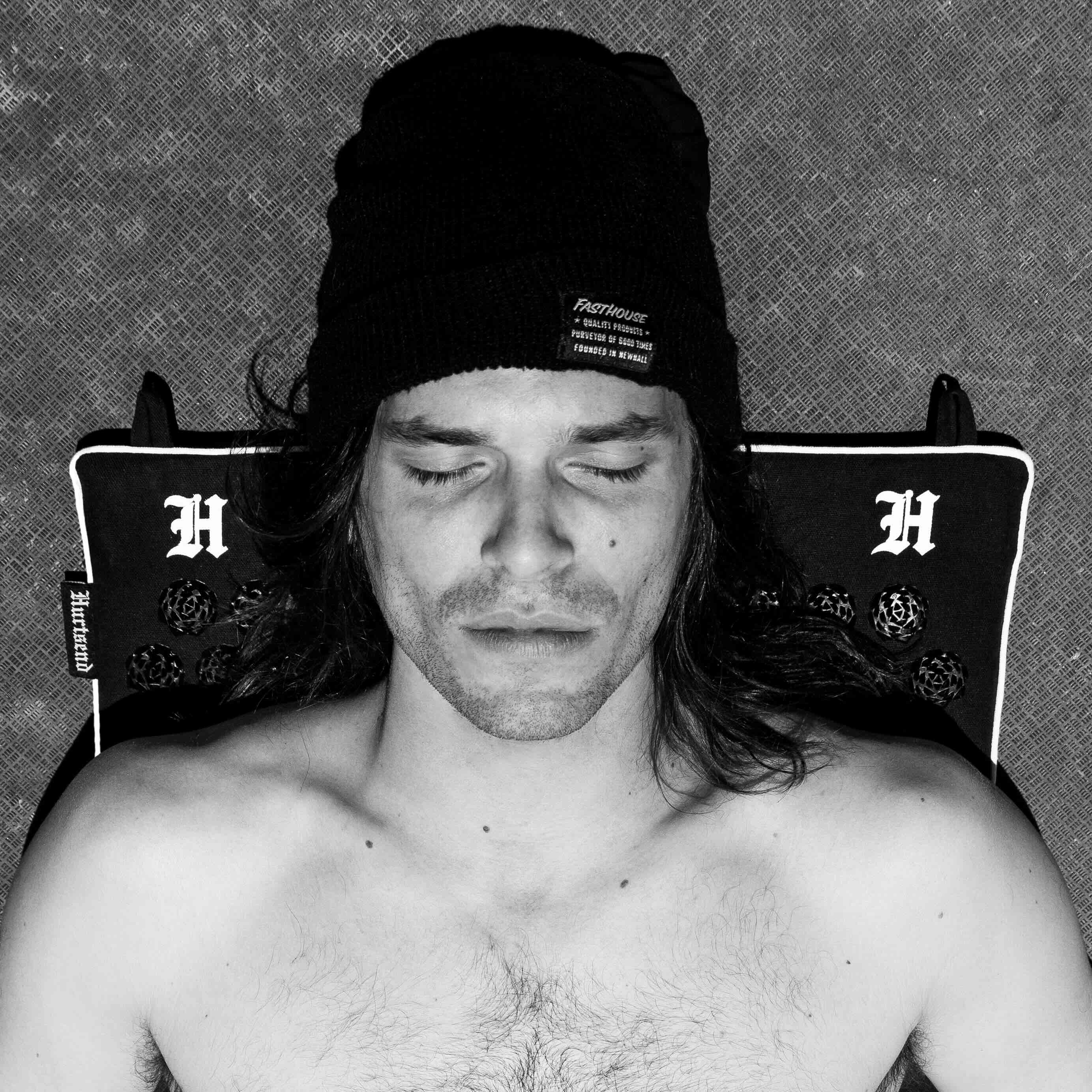 patrick evans laying on his deathmat by hurtsend which relieves back pain for motocross riders
